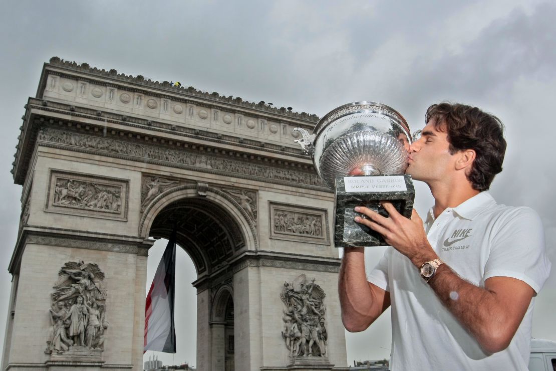 Roger Federer kisses the French Open trophy, having beaten Sweden's Robin Söderling (6-1, 7-6, 6-4) to complete the career grand slam.