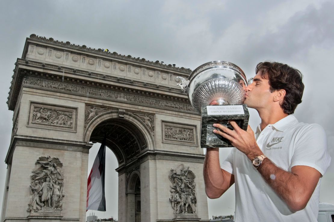 Roger Federer kisses the French Open trophy, having beaten Sweden's Robin S?derling (6-1, 7-6, 6-4) to complete the career grand slam.