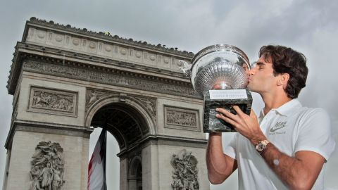 Roger Federer kisses the French Open trophy, having beaten Sweden's Robin Söderling (6-1, 7-6, 6-4) to complete the career grand slam.