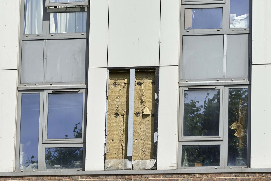 A hole remains where a panel of external cladding was removed Friday from a tower block on the Chalcots Estate in north London.