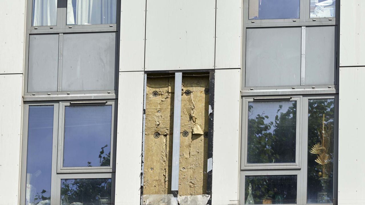 A hole remains where a panel of external cladding was removed Friday from a tower block on the Chalcots Estate in north London.