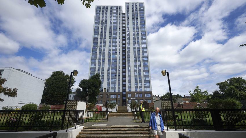 A resident walks down the steps in front of the Dorney residential tower block in north London on June 23, 2017.Tower blocks housing thousands of people across England are being urgently tested to check if their outer coverings pose a serious fire risk following the Grenfell Tower disaster, with nearly a dozen already testing positive for combustible material. 11 buildings have already been confirmed by the Government to have combustible cladding including five buildings on the Chalcots Estate in north London. Camden Council said in a statement that the external cladding panels on the five blocks at the estate did not satisfy their independent laboratory testing and that they would immediately begin preparing to remove them. / AFP PHOTO / NIKLAS HALLE'N        (Photo credit should read NIKLAS HALLE'N/AFP/Getty Images)