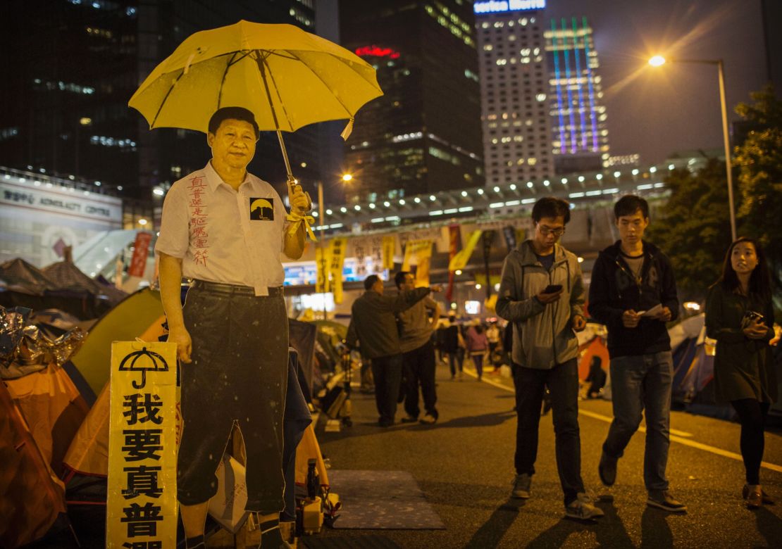 A carboard cutout of Chinese President Xi Jinping holding a yellow umbrella seen at a protest site in Hong Kong's Admiralty district on November 12, 2014.