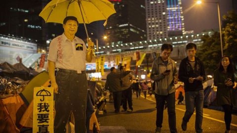 A carboard cutout of Chinese President Xi Jinping holding a yellow umbrella seen at a protest site in Hong Kong's Admiralty district on November 12, 2014.