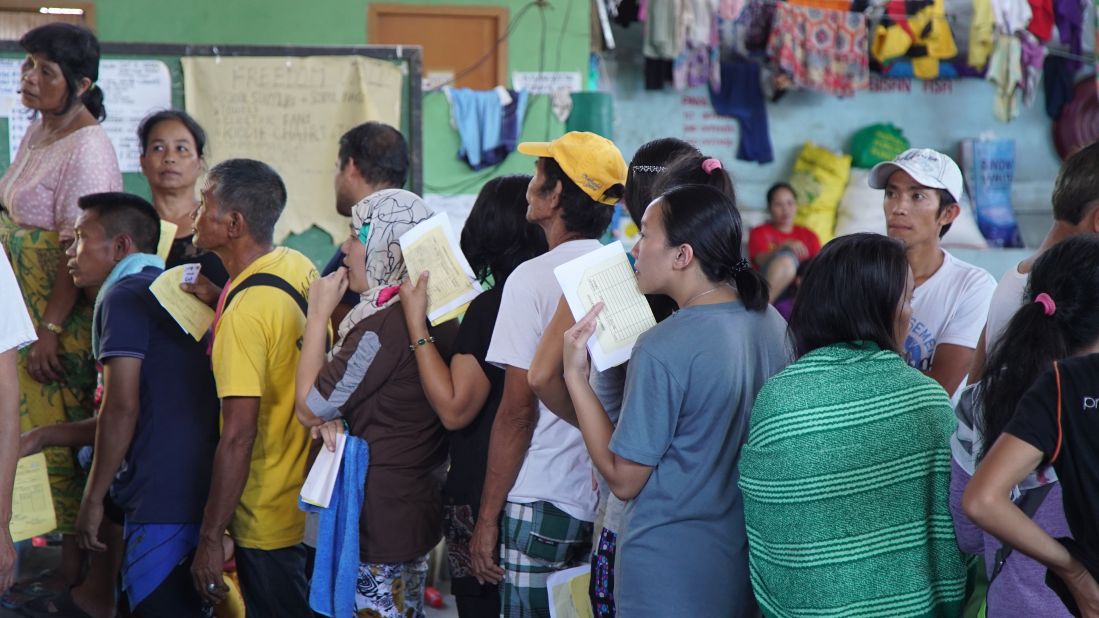 Internally displaced peoples (IDPs) line up at a makeshift camp in Barangay Maria Christina, Iligan City.