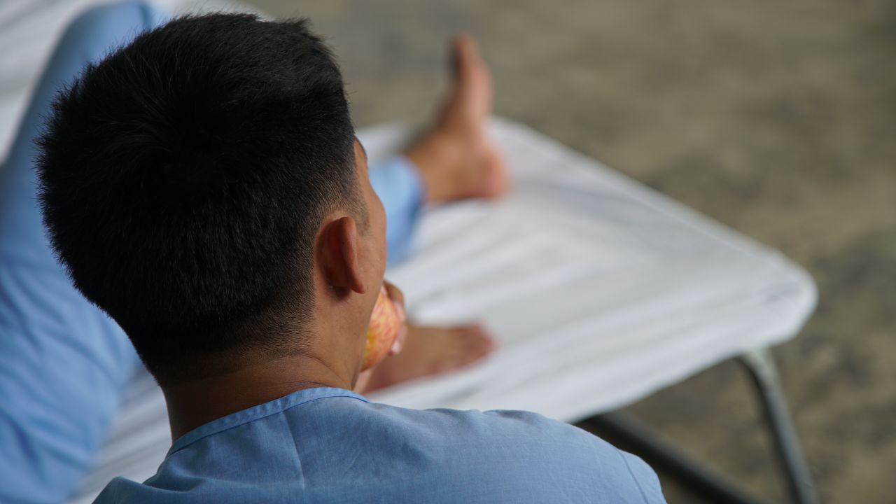 It's so overcrowded at Camp Evangelista that around 30 soldiers sleep in camp beds in an open-air hallway.