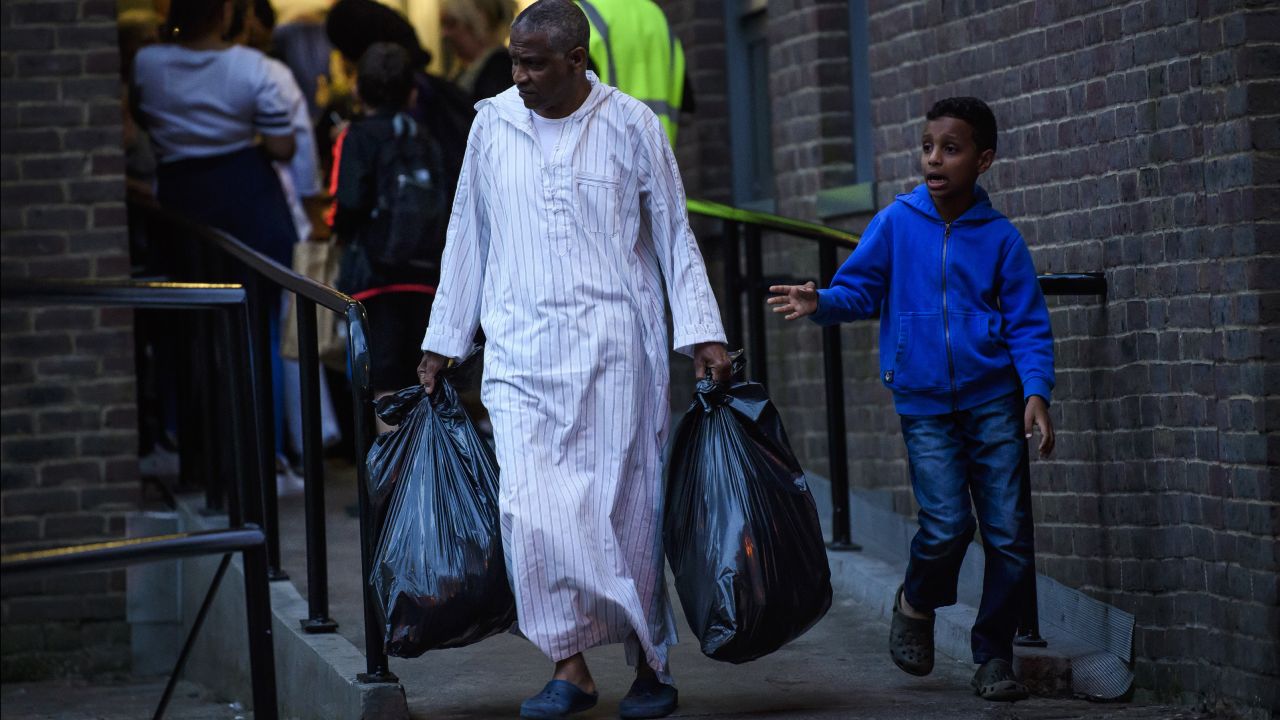 Residents leave a tower block on the Chalcots Estate on Friday after it failed a fire inspection.
