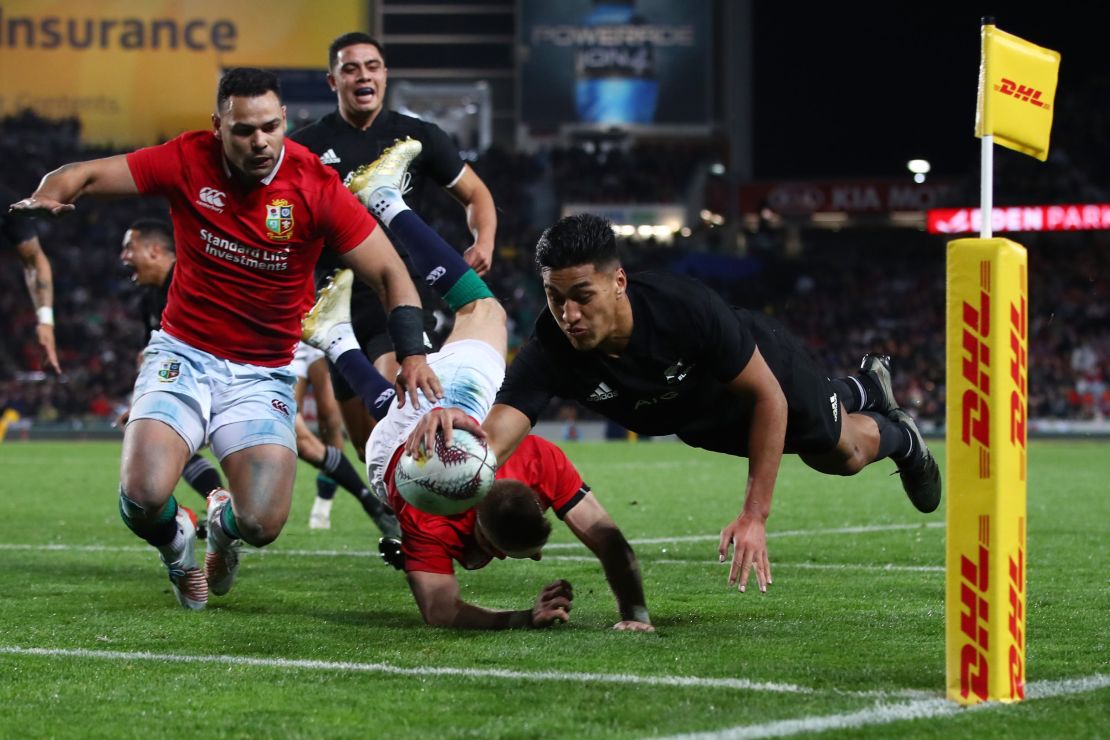 Rieko Ioane jumps over to score his first try of the game