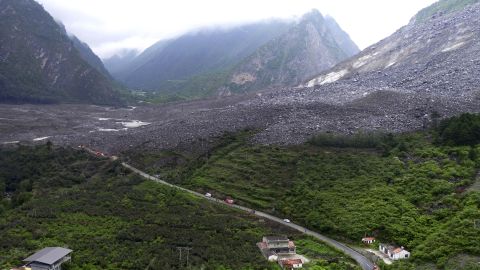 Vehicles and people line a road leading to the site of a landslide near Xinmo on June 24. 