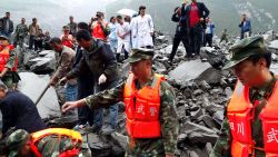 Chinese military police and rescue workers search the site of a landslide at the Xinmo village, in China's Sichuan province on, Saturday, June 24, 2017. Many people are feared buried after a landslide smashed through the village.  