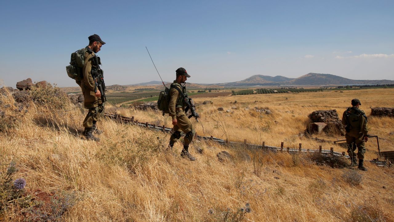 Israeli soldiers patrol near the border with Syria after projectiles fired from the war-torn country hit the Israeli-occupied Golan Heights on June 24, 2017.