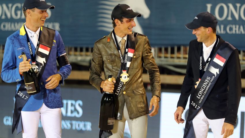Italy's Alberto Zorzi celebrates on the podium at the Global Champions Tour event in Monaco, flanked by Christian Ahlmann (left) and Kevin Staut.