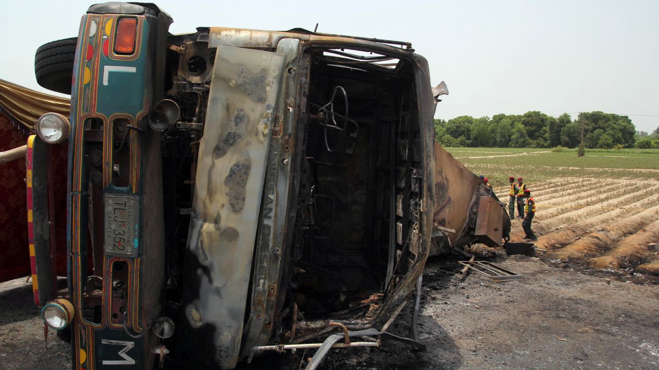Pakistani rescue workers gather beside the tanker truck.
