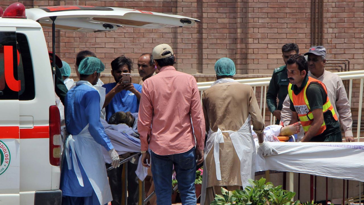 Pakistani paramedics bring a burn victim to a hospital in Multan, Pakistan.