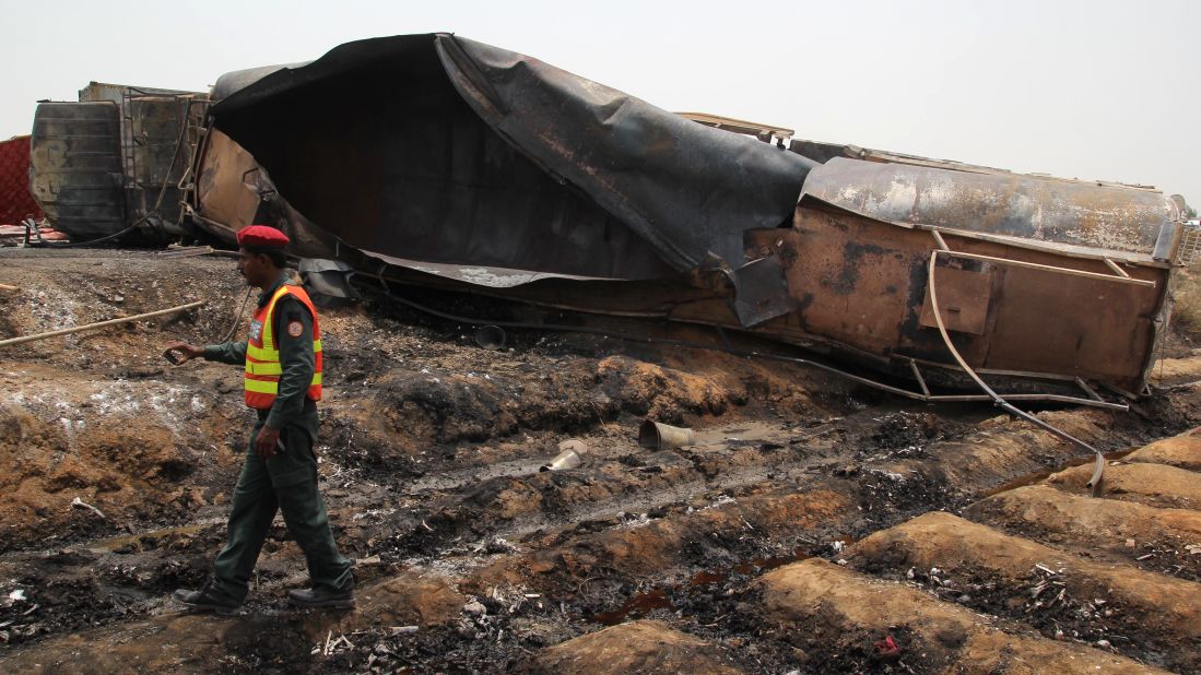 A Pakistani rescue worker walks by what remains of the tanker truck.