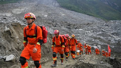 Rescue workers walk to the location where they will look for survivors of a massive landslide near Xinmo village in China's Sichuan Province on June 25. Heavy rains caused the side of a mountain to collapse onto the small village. 