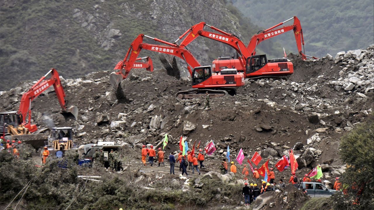 Rescue personal using front loaders search for missing people on June 25.
