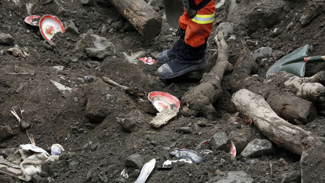 Household goods are scattered among the debris as rescue workers search for victims on June 25.