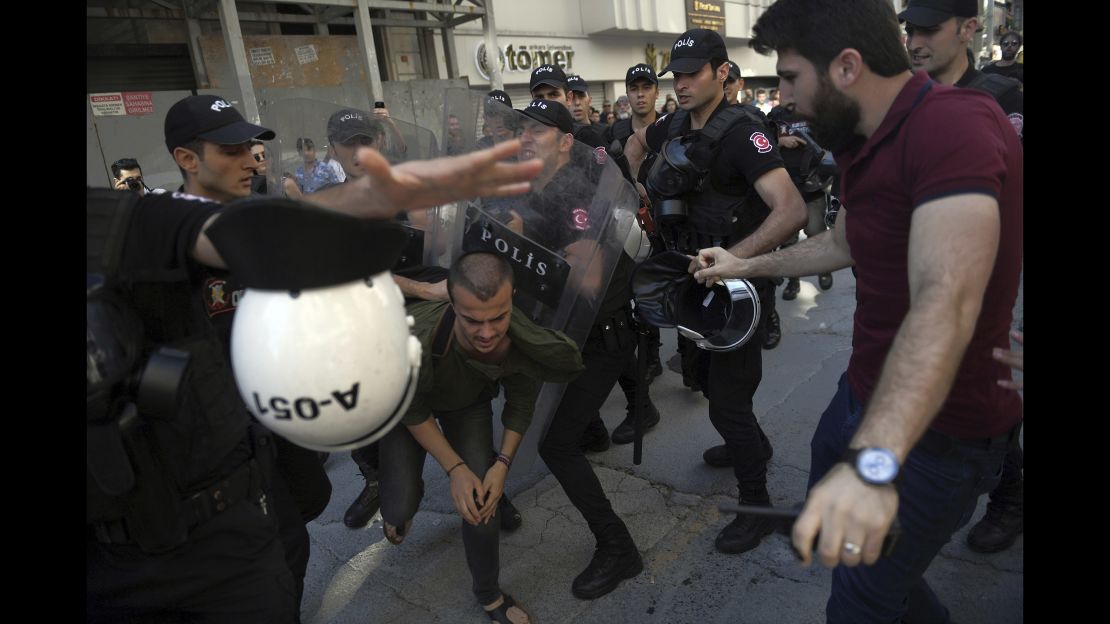 Riot police detain LGBTQ supporters in Istanbul.