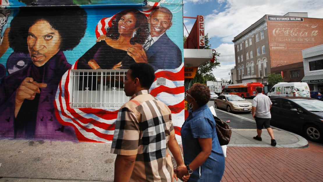 People visit a new mural at Ben's Chili Bowl, Friday, June 23, 2017, in Washington.