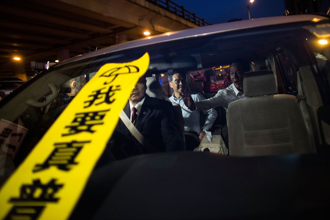 A banner with the Chinese characters "I want true universal suffrage" placed on the windscreen of a car carrying Hong Kong leader CY Leung. 