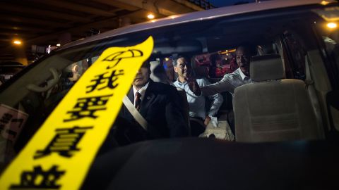 A banner with the Chinese characters "I want true universal suffrage" placed on the windscreen of a car carrying Hong Kong leader CY Leung. 