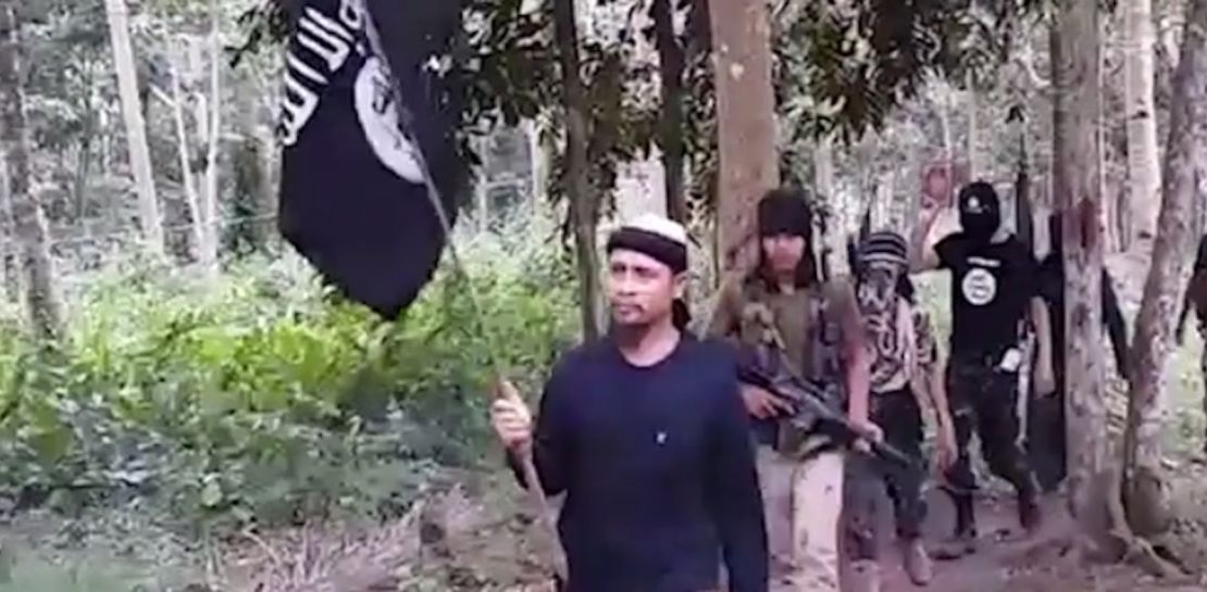Abu Sayyaf commander Isnllon Hapilon, seen here in a screen grab from a militant-released video, leading jihadis while holding an ISIS flag.