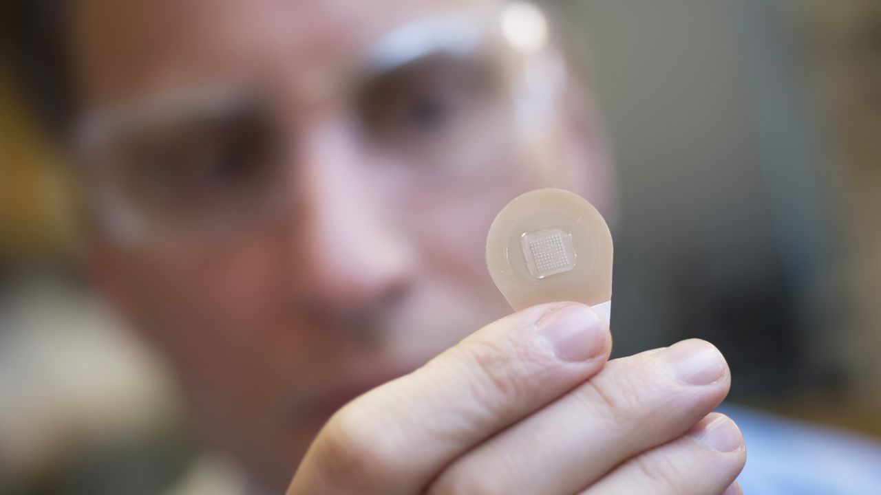 Mark Prausnitz, a Georgia Tech Regents professor in the School of Chemical and Biomolecular Engineering, holds a microneedle vaccine patch containing needles that dissolve into the skin.