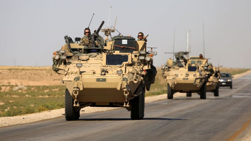 US troops sit atop an armoured vehicle on a road near the northern Syrian village of Ain Issa on June 3, 2017. / AFP PHOTO / DELIL SOULEIMAN        (Photo credit should read DELIL SOULEIMAN/AFP/Getty Images)