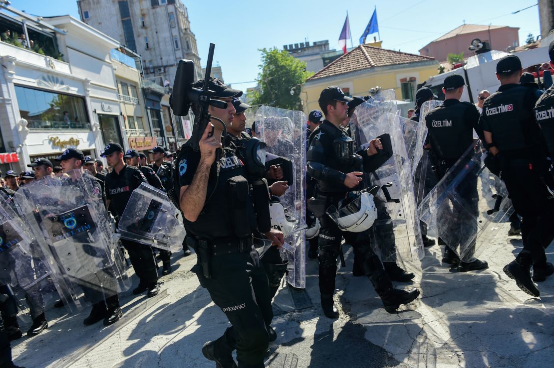 Turkish riot police officers block activists as they try to gather for the pride parade.