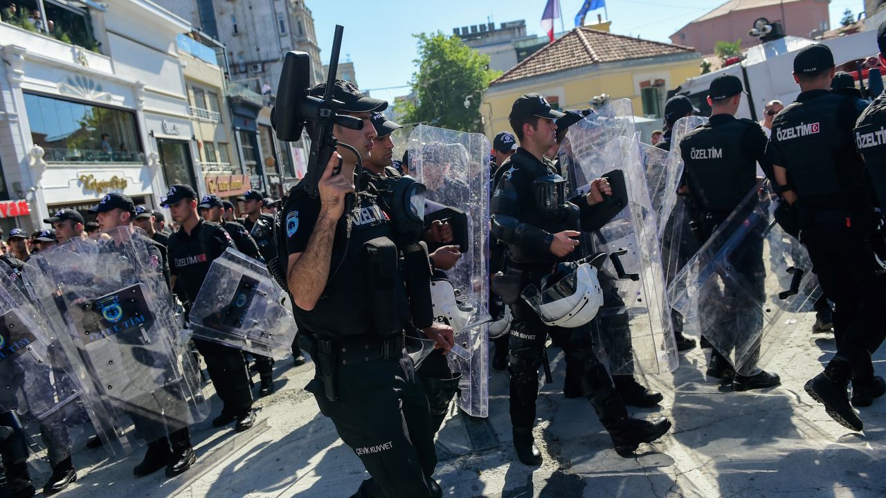 Turkish riot police officers block activists as they try to gather for the pride parade.