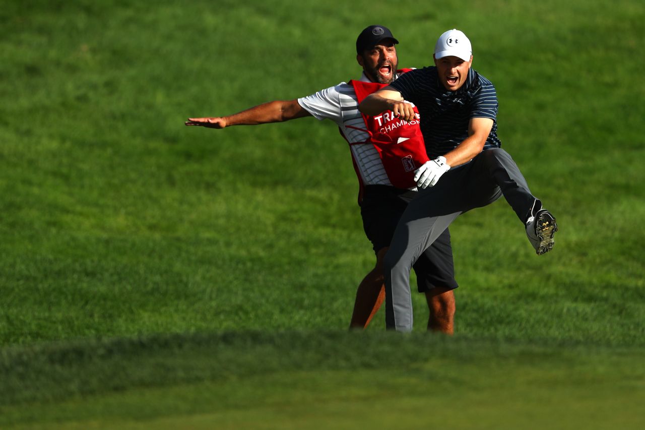 Jordan Spieth (right) and caddie Michael Greller celebrate after the US golfer holed a bunker shot to win the Travelers Championship. 