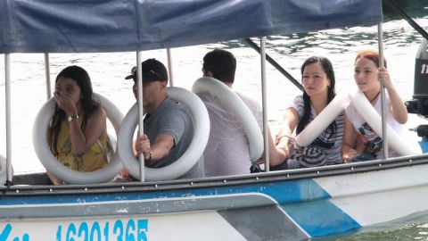 Survivors are taken to shore from the capsized boat on June 25, 2017.
