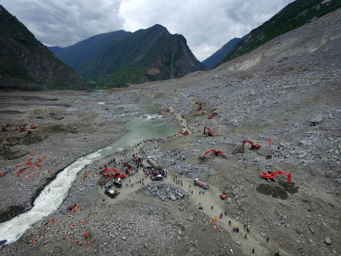 Chinese rescuers search for survivors at a landslide area in the village of Xinmo in Maoxian county, China's Sichuan province on June 25, 2017. 
