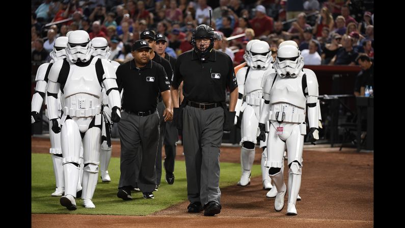 "Star Wars" stormtroopers escort umpires to home plate before a Major League Baseball game in Phoenix on Saturday, June 24. It was "Star Wars Night" at Chase Field.