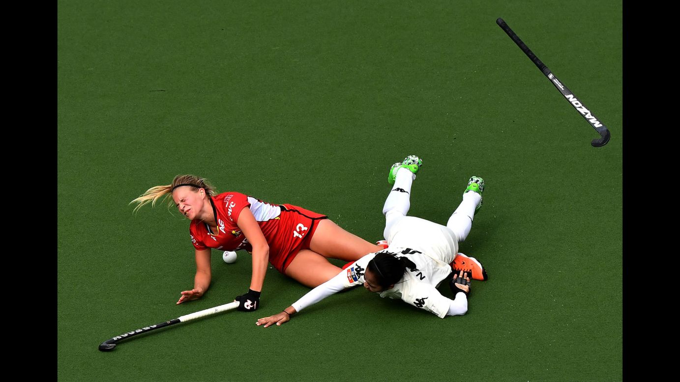 Belgium's Alix Gerniers, left, is fouled by Malaysia's Nurul Mansur during a Hockey World League game on Saturday, June 24.