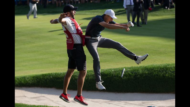 Jordan Spieth celebrates with his caddie, Michael Greller, after holing a bunker shot to win the Travelers Championship on Sunday, June 25. The shot came on the first playoff hole against Daniel Berger.