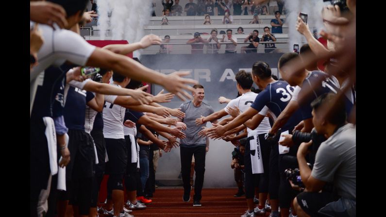 NFL quarterback Tom Brady is greeted by fans during a promotional event in Shanghai, China, on Tuesday, June 20.