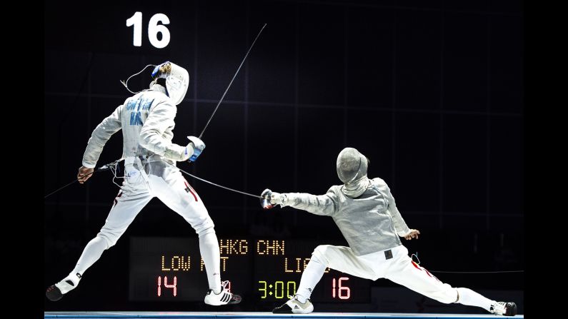 China's Jianhao Liang, right, competes against Hong Kong's Ho Tin Low during the Asian Fencing Championships on Tuesday, June 20.