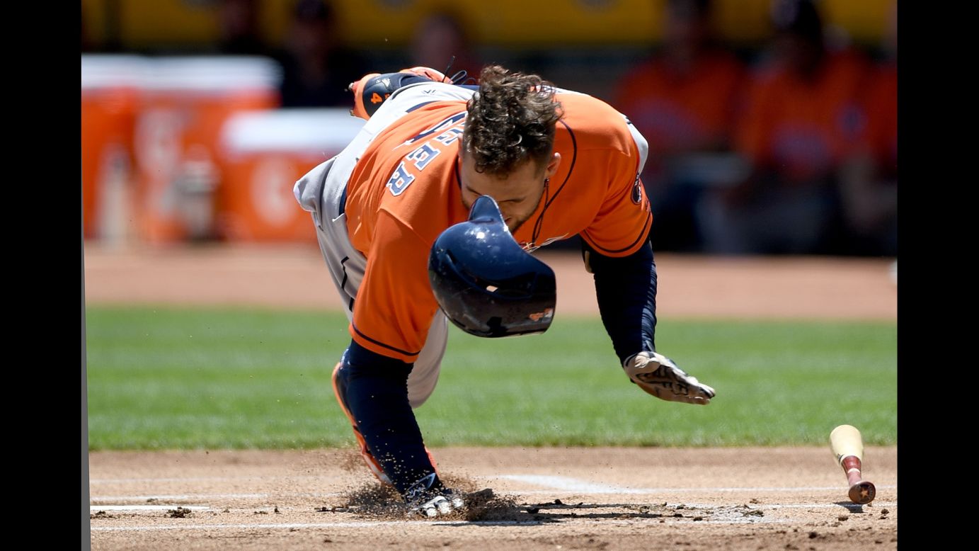 Houston's George Springer falls to the ground after his hand was hit by a pitch in Oakland, California, on Thursday, June 22. The injury forced him to leave the game, but X-rays were negative.