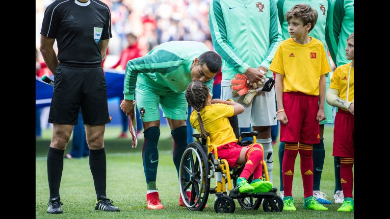 Portugal soccer star Cristiano Ronaldo kisses a young girl before a Confederations Cup match in Moscow on Wednesday, June 21.