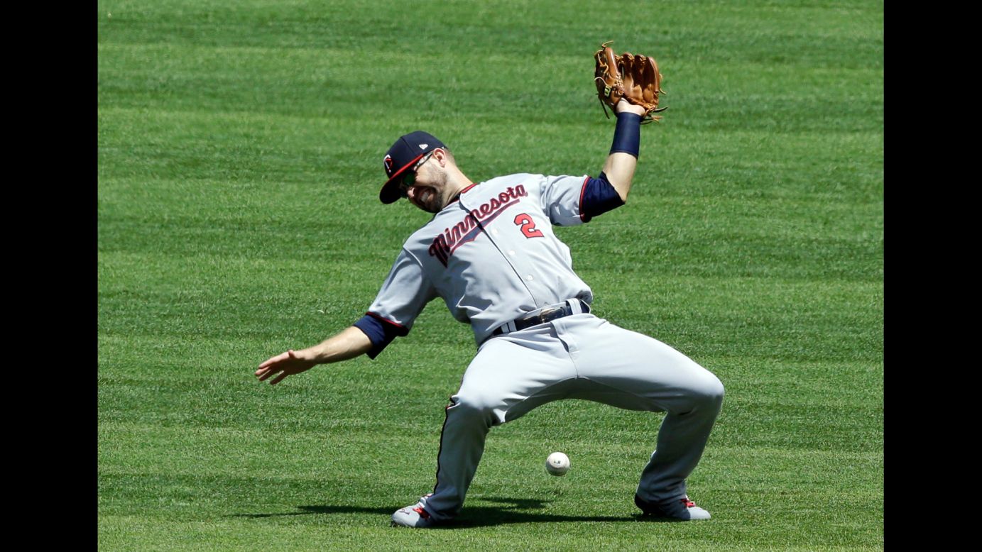 Minnesota second baseman Brian Dozier can't come up with a catch during a Major League game in Cleveland on Sunday, June 25.