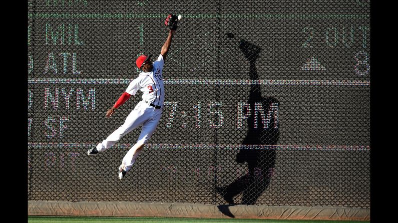 Washington center fielder Michael Taylor leaps for a ball during a Major League game on Saturday, June 24. Cincinnati's Scooter Gennett doubled on the play.