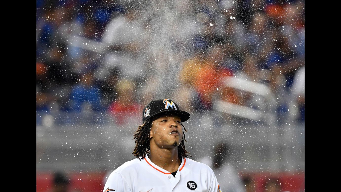 Miami pitcher Jose Urena sprays water while walking to the mound at Marlins Park on Friday, June 23. He went on to pitch six shutout innings against the Chicago Cubs.