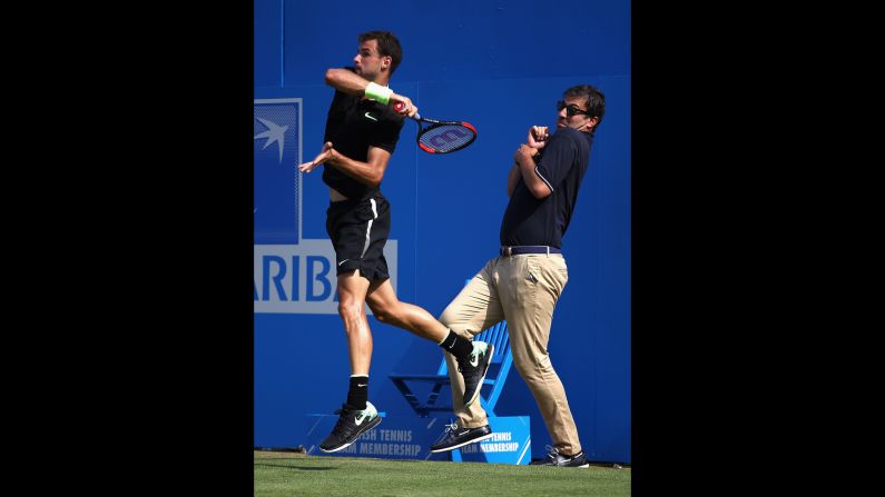 A line judge backs away as Grigor Dimitrov plays a shot at the Aegon Championships in London on Wednesday, June 21.