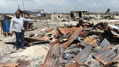 Community leader Celestine Ahisu points to family make-shift home demolished by the authorities at Otodo Gbame waterfront fishing communities in Lagos, on November 28, 2016.