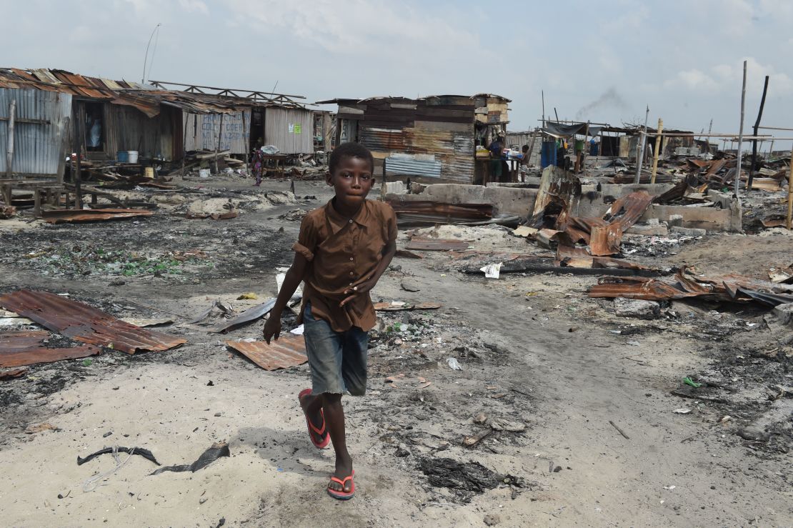 A boy walks past make-shift structures demolished by the authorities at Otodo Gbame waterfront fishing communities in Lagos. 