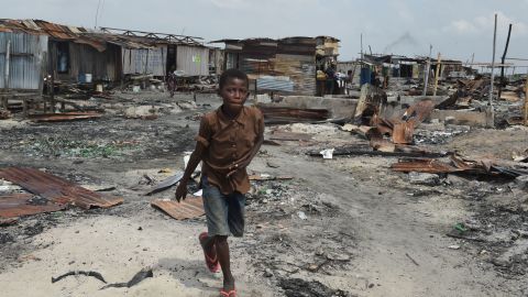 A boy walks past make-shift structures demolished by the authorities at Otodo Gbame waterfront fishing communities in Lagos.