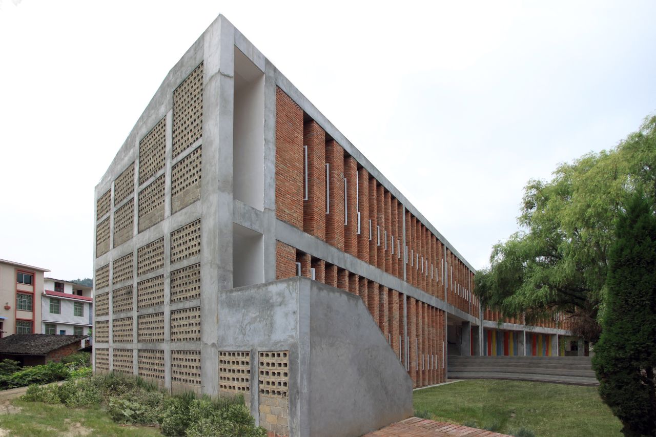 For this "recycled brick school", Bolchover and Lin collected bricks from nearby demolition sites and used them to build ground paving and a screen wall.
