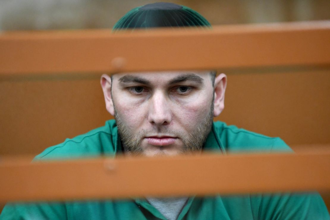 Accused Shadid Gubashev stands inside a defendants' cage at a court hearing in Moscow on Tuesday.